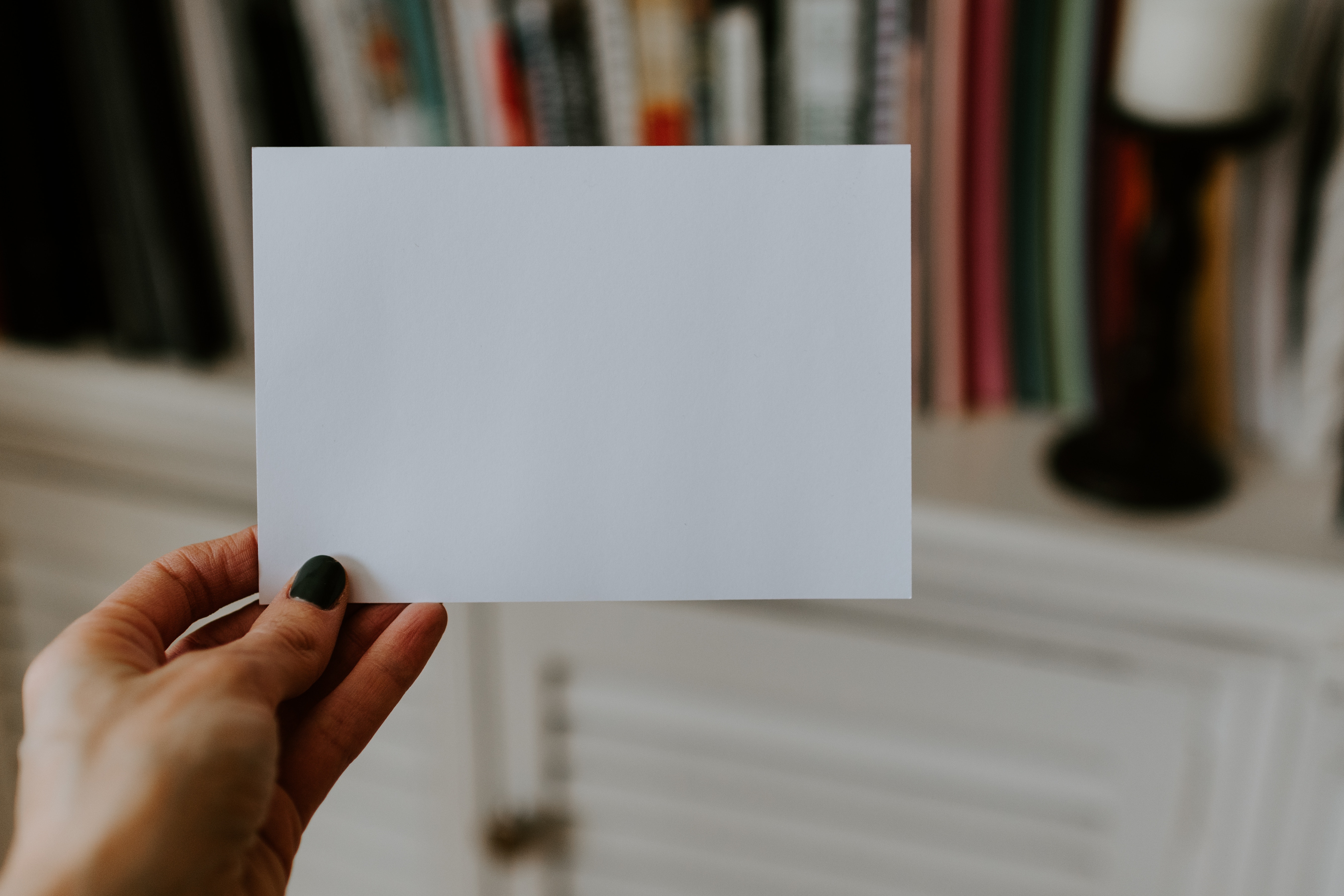 person holding blank index card